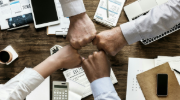Four partners fist bumping.